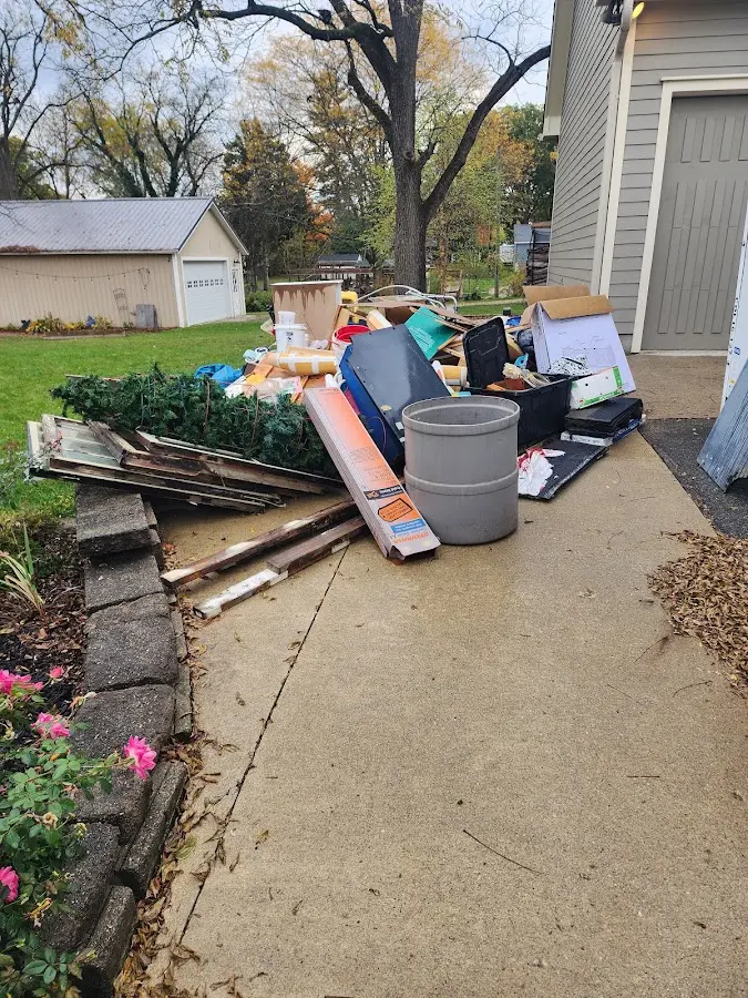Dumpster being loaded with debris for 12 Yard Dumpster Rental in Bradenton